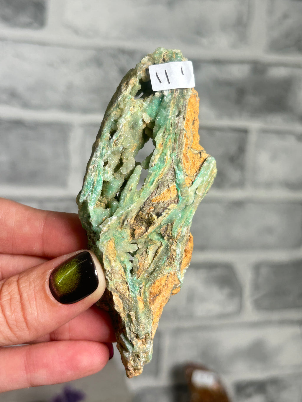 Indonesian Smithsonite trade-name specimen I from Indonesia with mint-green garnierite, crystalline quartz cavity and contrasting rust-orange matrix.