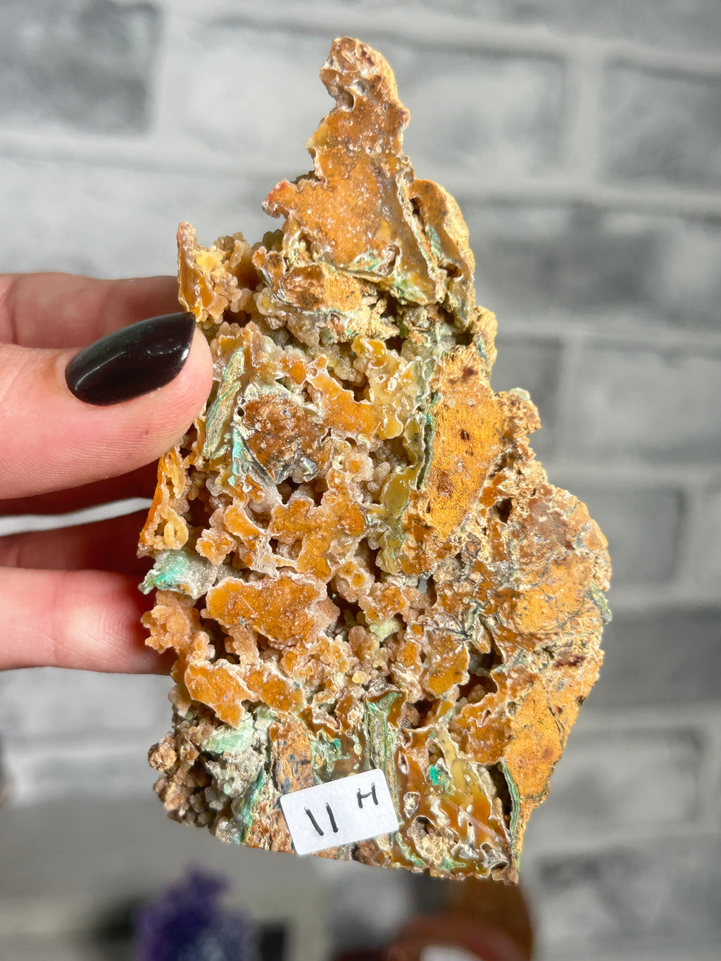 Indonesian Smithsonite trade-name specimen G from Indonesia with amber honey-toned quartz crystal growth, open cavities and green garnierite mineralisation.