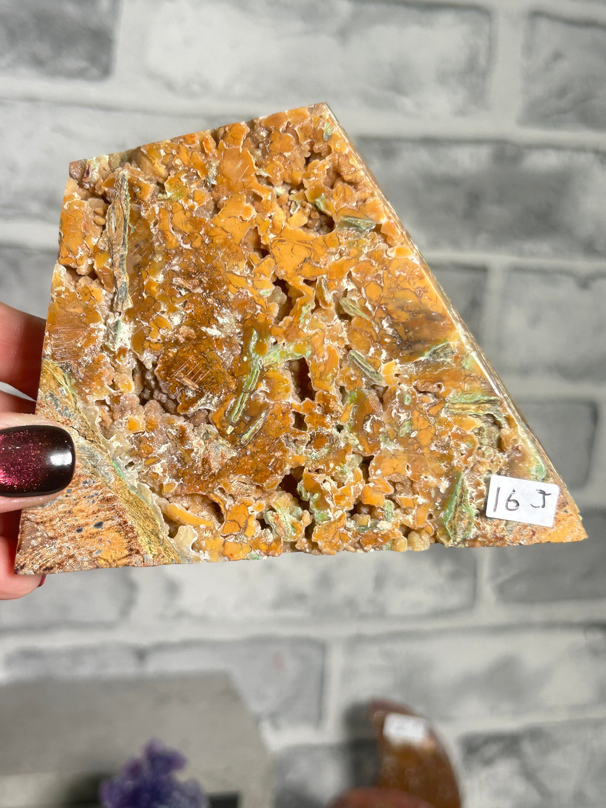 Indonesian Smithsonite trade-name specimen J from Indonesia with honey-orange quartz crystal growth, green garnierite seams and textured natural matrix.