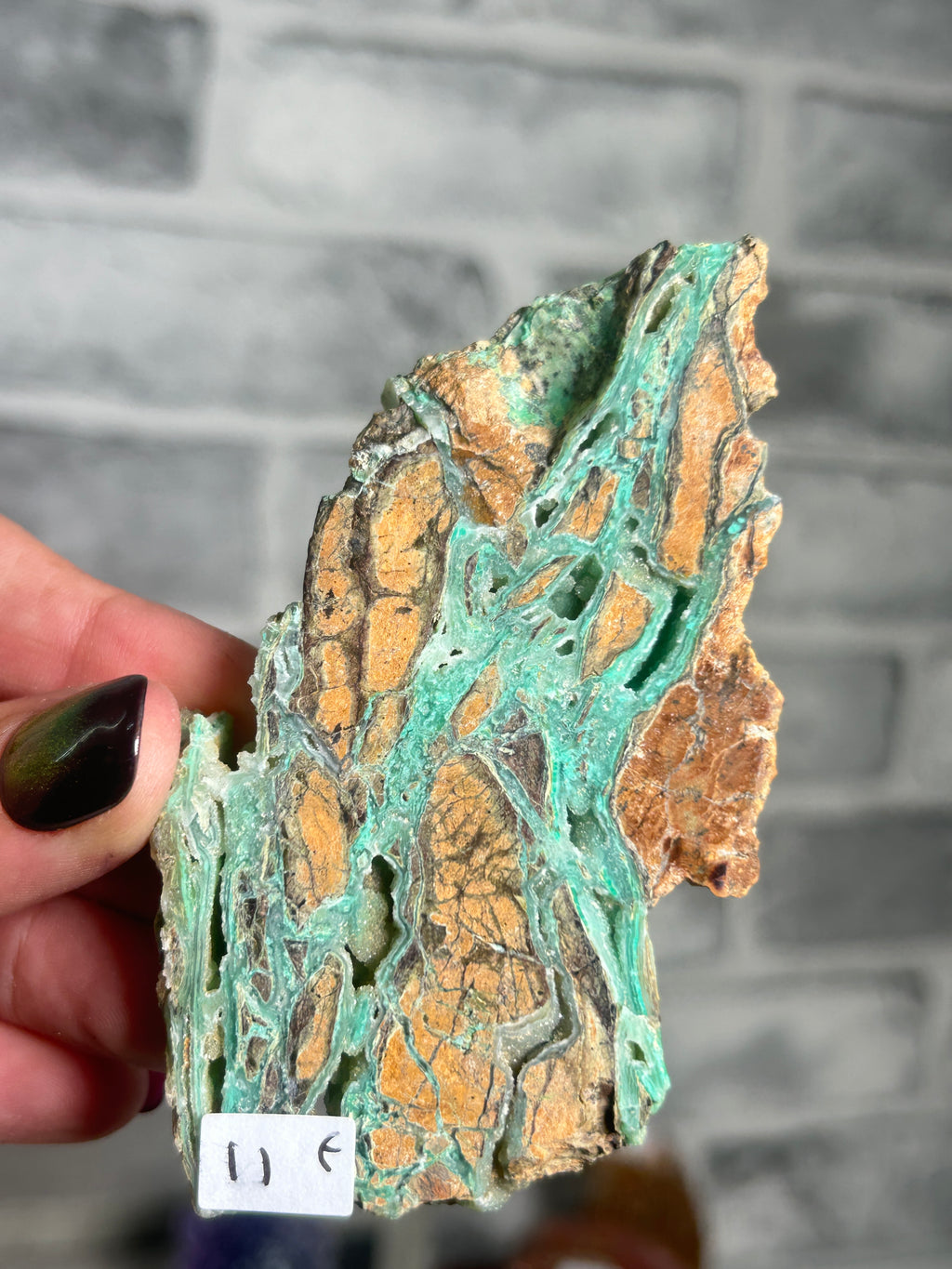 Indonesian Smithsonite trade-name specimen F from Indonesia with vivid turquoise-green garnierite veins through contrasting rust-orange natural matrix.